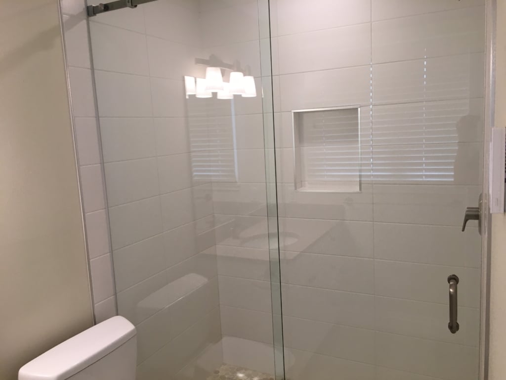 cleaning glass shower doors - bathroom renovations